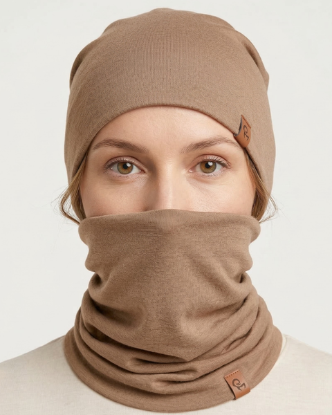 Woman wearing beige merino wool beanie and neck gaiter, soft breathable merino winter accessories for cold weather.