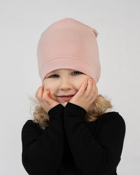 Kids bamboo beanie in soft pink, lightweight and gentle hat for sensitive skin.