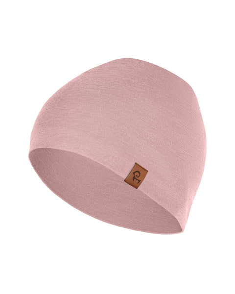 A product shot of a solid dusty pink beanie hat against a pure white background. The fabric is smooth, and the hat features a small, square brown leather logo patch on the lower right edge.