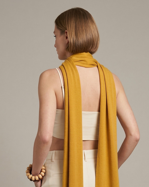 Woman wearing yellow merino wool scarf soft lightweight breathable wrap for all seasons