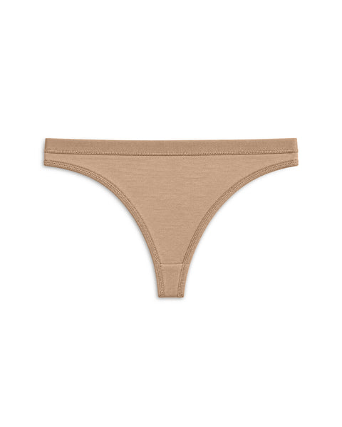 Product flat lay of minimalist seamless beige bikini briefs against a plain white background.